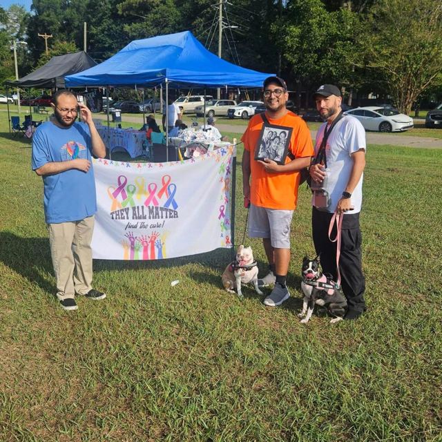 Volunteers at the They All Matter banner at the Cancer Walk