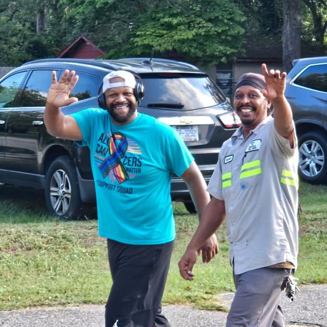 Two walkers waving at the camera