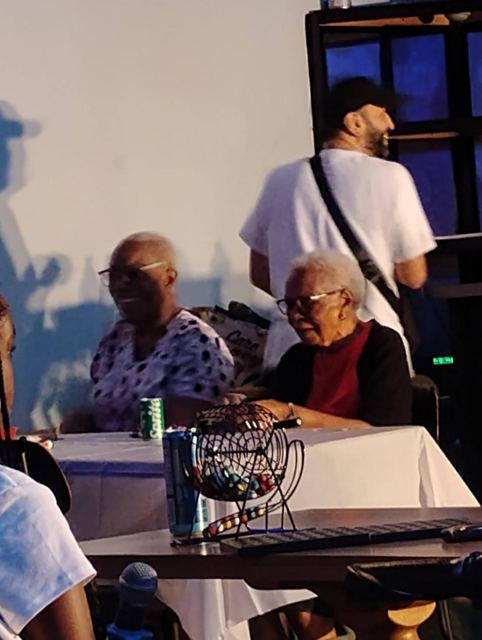 Players with the bingo cage